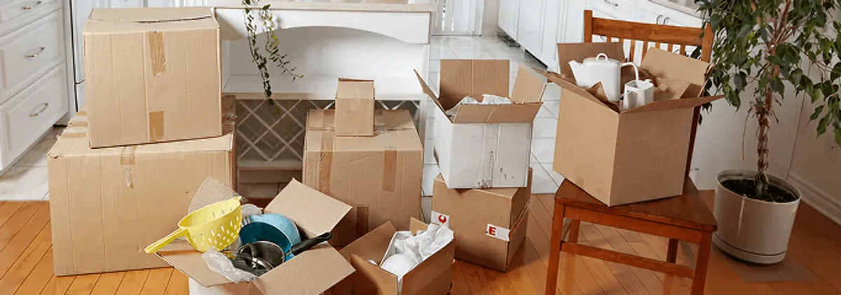 Packed moving boxes and household items in a kitchen before move-out or move-in cleaning, Columbia, SC.